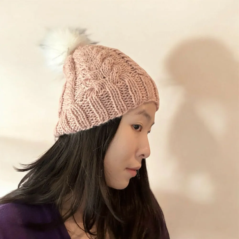 Cable Hand Knit Slouchy Beanie in beige pink with white fur pompom
